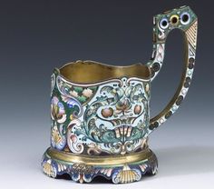 an ornately decorated coffee cup with gold rim