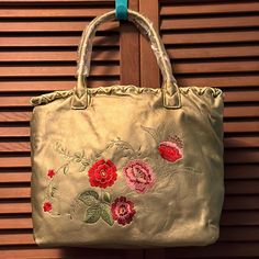 Floral Metallic Tote Bag. Pink, Red And Green Floral Embroidery On One Side. 2 Short Handle Straps. Large Tote Section. 2 Zippered Pockets And One Phone Pocket. Edge Trimmed With Leather Like Twine And Eyelets. Snap Closure. Never Used. Gold Tote Gift Bag, Gold Embroidered Tote Bag, Gold Embroidered Shoulder Bag, Avon Bags, Diy Fashion Clothing, Large Tote, Diy Fashion, Womens Tote Bags, Floral Embroidery