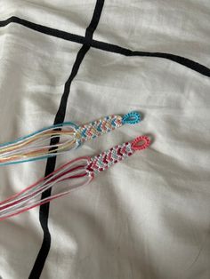 three different colored beads on a white cloth