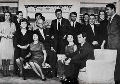 a group of people are posing for a photo in an old black and white photo