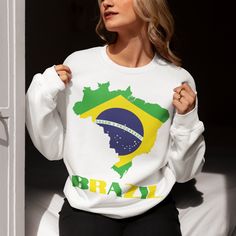 Show your love for Brazil with this cozy Brazilian Flag Map of Brazil Sweatshirt! Perfect for fans of Brazilian recipes, South America destinations, and exploring iconic Brazilian cities like Rio de Janeiro, Sao Paulo, and Brasilia. Whether you're looking for a stylish Brazil airport outfit, Portuguese language teacher outfit, or something to wear while supporting your favorite Brazilian soccer players, this cute Brazil shirt is a versatile choice. Made from soft, durable fabric, this Brazil flag sweatshirt is ideal for showing off your passion for Brazilian culture and South America history. Get your Brazil crewneck today and represent Brazil in style wherever you go! Brazil Sweatshirt, Brazil Airport, Brazil Outfit, Map Of Brazil, South America History, Brazilian Soccer Players, Travel Brazil, Brazilian Soccer, Brazilian Culture