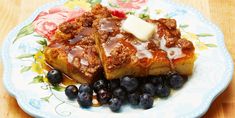 two pieces of french toast on a plate with blueberries