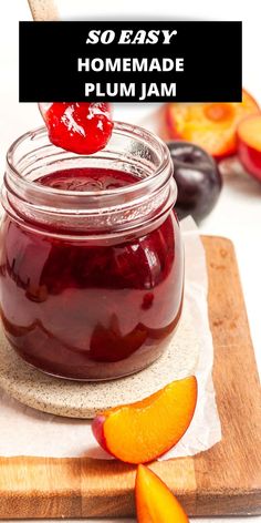 homemade plum jam in a glass jar on a cutting board