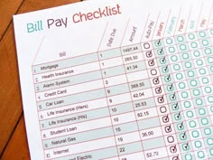 a bill pay checklist sitting on top of a wooden table