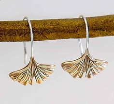 These solid bronze Ginkgo leaf earrings have a lovely, graceful shape and beautiful texture. The bronze leaves are polished to a bright gold as they flow into the sterling silver of the earwires. The Ginkgo tree, sacred in many ancient cultures, is the oldest surviving species of tree known to exist. With a history spanning 200 million years, the Ginkgo has become a symbol of strength, hope, and peace. Ginkgo Tree, Symbols Of Strength, Ginkgo Leaf, Leaf Jewelry, Bright Gold, Ancient Cultures, Beautiful Textures, Garden Gifts, Leaf Earrings