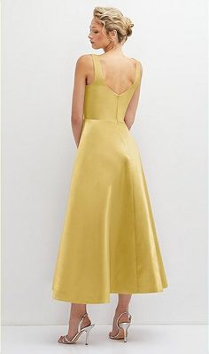 a woman in a yellow dress looking back