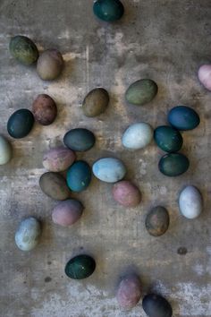 several different colored rocks on a cement surface