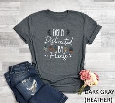 "Easily Distracted By Plants Shirt, Plant Lady Gift, Love To Garden Shirt, Gardener Gift Tee, Gardening Shirt, Mom Graphic Shirt, Funny Plant Lady Shirt *HOW TO ORDER: 1. Please, Check and Review all Photos and Size Charts (The V-necks and Tank Tops are Women's Size, The other styles are Unisex) 2. Choose Your T-Shirt Color/Size (You can see youth and toddler options in the same drop-down menu) 3. Choose Your Quantity as much as you want. 4. Click \"Add To Cart\". For multiple items go back to t It Takes A Village, Takes A Village, Funny Nurse Shirts, Wine Mom, Funny Mom Gifts, Wine Shirts, Gardening Shirts, Inspirational Shirt, Gifts For Wine Lovers