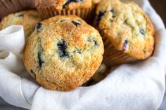 blueberry muffins in a basket on a napkin