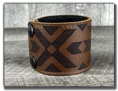 "Our leather cuffs are made from high quality full grain leather on the outside and softer pigskin for durable comfort on the inside. Our cuffs come in two sizes, small and large, each of which can be adjusted to two positions so we should have one to fit your wrist. Size: * Our cuffs are available in two sizes, small/medium and large/x-large * Small/Medium cuff (for wrists up to 7 1/4\") can be adjusted to 6\" or 7 1/4\" * Large/X-Large cuff (for wrists over 7 3/4\") can be adjusted to 8\" or 9 Western Style Leather Bracelets For Gift, Western Style Leather Bracelet Gift, Western Leather Bracelet As A Gift, Western Leather Bracelets, Western Style Leather Bracelets As Gifts, Western Style Hand Tooled Leather Bracelets, Adjustable Leather Bracelet, Brown Western Style Leather Bracelet Gift, Leather Concho Bracelet As Gift