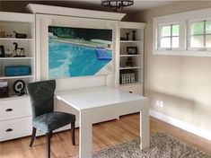 a room with a desk, chair and bookcases in front of a swimming pool