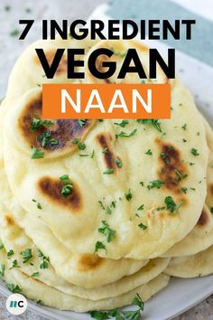 several flat breads stacked on top of each other with the words 7 ingredient vegan naan