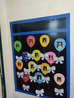 a wall hanging with pictures and balloons attached to it's sides in the shape of hearts