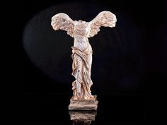 an angel statue is shown on a black background