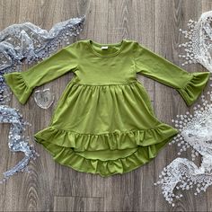 #26 Olive Green Hi-Lo Ruffle Tunic/Dress. Junipers Boutique Label 100% Organic Cotton. 28 Colors Available. Cute Solid Dresses With Ruffle Hem, Solid Color Dresses With Ruffles In Cute Style, Spring Twirl Dress With Ruffles For Dress-up, Cute Flowy Twirl Dress With Ruffles, Casual Flowy Twirl Dress With Ruffles, Green Spring Twirl Dress With Ruffles, Spring Green Twirl Dress With Ruffles, Cute Green Dresses With Ruffles, Cute Green Ruffled Dresses