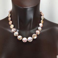 These coin pearls are special! They are solid nacre since they were tissue nucleated. They have not been bleached, so they are a soft pink/cream color and are particularly lustrous. You could wear these for the wedding and then keep wearing them! Looks great with jeans or in the office, or for the opera, and simple enough for everyday wear since it is really a neutral color. They are knotted on silk and finished with my signature beads and a handsome clasp in sterling silver. They will come pack Elegant Iridescent Round Bead Necklaces, Elegant Iridescent Necklace With Round Beads, Elegant Iridescent Beaded Necklace, Formal Pink High Luster Necklace, Pink Pearl Drop Necklace For Formal Occasions, Formal Pink Pearl Drop Necklace, Pink Round Pearl Necklace Gift, Pink High Luster Round Pearl Necklace, Pink High Luster Pearl Necklace