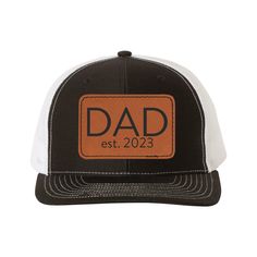 "Make Father's Day extra special with our personalized leather patch trucker hat, featuring a laser engraved design of Dad, Papa, or Grandpa. ------------------- ➤HOW TO ORDER: 1. Choose your Hat and Patch color 2. In the personalization box, please let us know the design you would like.  Designs D1-12 are NON CUSTOM and the fonts and words will be EXACTLY as shown. 3. If you want something other than DAD, GRANDPA or PAPA, choose Design D15.  In the personalization box, please let us know the design option you like and the replacement word (example: Use D9, change text to Uncle est. 2022) 4. For designs D13 and D 14. Please let us know which dates to use (up to 5 max). 5.  Add to cart! ------------------- ➤PRODUCT FEATURES: Custom Richardson 112 Trucker Style Snapback Hats  Heather Grey/Bl Richardson Hats, Leather Patch Hat, Patch Hat, Hat Patches, Personalized Leather, Dad Hat, Color 2, Custom Leather, Leather Patches