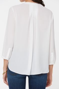 NYDJ's Pintuck Pleat Back Women's Blouse boasts a billowy long sleeve silhouette that's perfect when paired with any of our slimming Women's denim styles. Pleating at the back yoke creates a sophisticated yet easy drape. Split round neckline with covered full front placket and button closure. | NYDJ Women's Pintuck Blouse in Optic White, Regular, Size: Medium | Denim White Billowy Top For Work, White Billowy Tops For Workwear, Elegant Long Sleeve Blouse For Casual Gatherings, Elegant Blouse With 3/4 Sleeves For Daywear, 3/4 Sleeve Relaxed Fit Blouse For Work, Classic 3/4 Sleeve Blouse For Fall, Chic Top With Blouson Sleeves And 3/4 Sleeve, Classic 3/4 Sleeve Fall Blouse, Relaxed Fit 3/4 Sleeve Blouse For Work