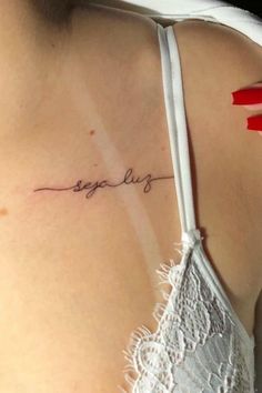 the back of a woman's shoulder with an inscription on it that says tequila