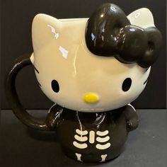 a hello kitty skeleton coffee mug with black ears