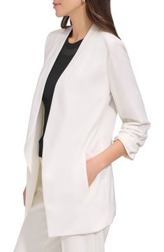 Ruched sleeves and an open front add contemporary appeal to a versatile blazer with just the right hint of stretch. 29 1/2" length Open front Three-quarter sleeves Front welt pockets 95% polyester, 5% spandex Dry clean Imported Women's Clothing Elegant Stretch Solid Color Blazer, Modern Career Outerwear For Spring, Modern Spring Career Outerwear, White Open Front Outerwear For Work, Elegant White Open Front Outerwear, Sleek White Outerwear For Work, Elegant Open Front Solid Color Blazer, Elegant Open Front Office Blazer, Elegant Open Front Blazer For Office