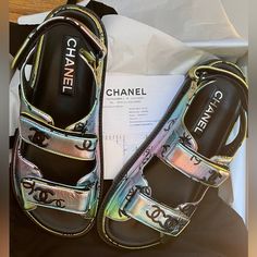 Gorgeous Brand New Chanel Dad Sandal. Brand New With Tags. Size 37 But Fits A 37 And A Half Too. Purchased In Chanel Store. Comes With Everything Dust Bags, Shopping Bag, Chanel Ribbons, And Receipt. Amazing Metallic Color That You Can Style With Multiple Outfits Chanel’s Newest Season Drop. Chanel Flip Flops, Chanel Ribbon, Chanel 2023, Black Block Heel Sandals, Dad Sandals, Chanel Black And White, Toe Ring Sandals, Yellow Sandals, Chanel Store