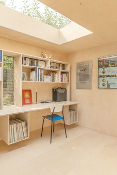 an image of a home office with bookshelves and desk in the room that has skylights above it