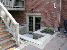 a brick building with stairs leading up to the front door and an open fire hydrant