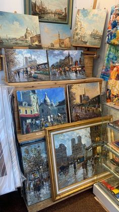 many paintings are on display in a store