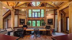 an empty recording studio with lots of sound equipment on the desks and in front of large windows