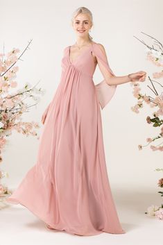 a woman in a long pink dress posing for the camera with flowers around her neck