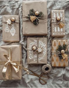 christmas presents wrapped in brown paper and tied with twine, pine cones, baubs and ornaments