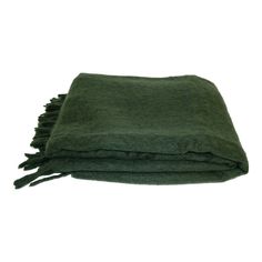 the green blanket is folded on top of it's own, with fringes