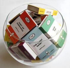 a glass bowl filled with different types of candy bars on top of a white table