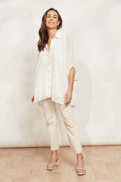 STYLE DETAILS: Workwear that does weekends, the Sereno Relaxed Shirt is the ultimate multitasker. In a relaxed fit, this shirt offers a flattering fit for all shapes and sizes. It features classic details, elevated by batwing sleeves, a flowing high-low hem, and shimmering lurex threading for that extra sparkle. Tuck it into a maxi skirt for a professional look or with fitted denim jeans for a chic weekend vibe. FEATURES: Collar Button-down Elbow-length batwing sleeves with cuff Lurex threading High-low hem Relaxed fit 100% Polyester Lining: 100% Rayon One Size Relaxed Fit Shirt For Daywear, Spring Daywear Shirt With Relaxed Fit, Chic Shirt For Daywear With Relaxed Fit, Relaxed Fit Shirt With Shirttail Hem For Daywear, Chic Relaxed Fit Shirt For Daywear, Relaxed Collared Shirt For Daywear, Relaxed Collared Blouse For Daywear, Relaxed Fit Blouse With Shirttail Hem For Daywear, Relaxed Fit Shirt With Rolled Sleeves For Daywear