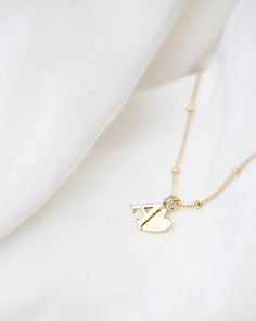 "Personalized 14k solid gold initials necklace with beautiful beaded chain. Simple, minimalist everyday necklace. Perfect wearing alone or layering with your favorite necklaces. Each initial measures approx. 7mm, You can add up to 5 Initials (Heart counts as ONE initial ) Chain Length: 18\" Available in 14K Yellow Gold * Leave us your initials and placement in the comment box at checkout." Dainty 14k Gold Initial Necklace With Charms, 14k Yellow Gold Charm Necklace With Satellite Chain, 14k Yellow Gold Satellite Chain Charm Necklace, Yellow Gold Minimalist Initial Necklace With Heart Charm, Minimalist Yellow Gold Initial Necklace With Heart Charm, Dainty 14k Yellow Gold Filled Initial Necklace, Yellow Gold Sterling Silver Charm Necklace With Satellite Chain, Minimalist Gold Name Necklace With Heart Charm, Minimalist 14k Gold-filled Initial Necklace