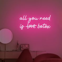 a pink neon sign that says all you need is love botox on the wall