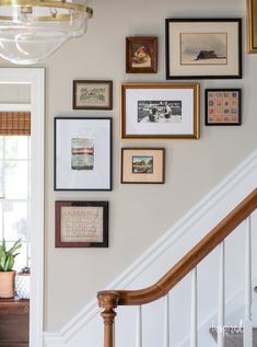 a staircase with many framed pictures on the wall