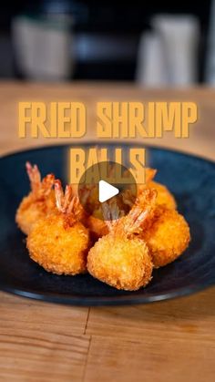 fried shrimp balls on a black plate with the words fried shrimp balls in front of it