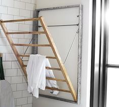 a wooden ladder hanging from the side of a wall