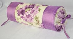 a roll of fabric with purple flowers on it