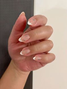 Minimal french tip nails with stars and jewel designs. Christmas theme. Small Star Nail Art, White Gold Star Nails, Drawn Sparkle Nails, Almond French Tip With Stars, Short Round New Years Nails, French Tip With Jewels Nails, White Star Nail Design, White French Tip Nails With Stars, French Manicure With Stars