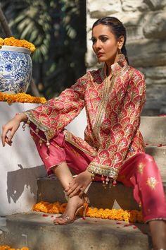 A fresh spin on a classic silhouette - a coral printed khaddi silk jacket with gota and zardoze work and colourful tassel details. The look is completed with a coral raw silk shalwar embellished with embroidered floral motifs. Heena Kochar, Bridal Suits Punjabi, Bridal Suits, Suits Punjabi, Coral Print, Party Suits, Silk Jacket, Designer Dresses Indian