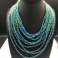 ON SALE Designer signed BARRERA Very pretty aqua glass 12 strand high and necklace in excellent vintage condition. Very pretty addition to any collection or wardrobe. Turquoise Multi-strand Necklace For Party, Elegant Multi-strand Turquoise Beaded Necklaces, Moonglow Necklace, Desert Hot Springs, Costume Jewelry Sets, Aqua Glass, Multi Strand Necklace, Glass Bead Necklace, Strand Necklace