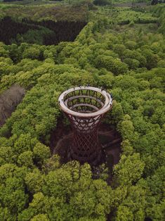 an aerial view of a tower in the middle of a forest