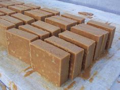 several squares of brown soap sitting on top of a white table covered in wax paper