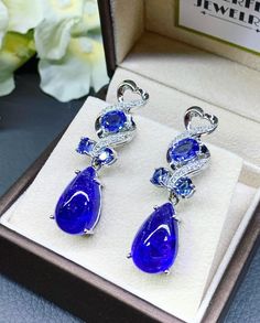 "BRAND-NEW!! ONE OF A KIND, HANDCRAFTED EARRINGS. So Perfect Jewelry proudly presents!! HUGE 2-in-1 PAIR! Delicately handcrafted, HUGE TANZANITE CABOCHON TEARDROP EARRINGS! With 6 pcs of sparkling Cornflower Blue Ceylon Sapphires! Accented with superb quality, natural diamonds, set in handcrafted 18K solid white gold earrings. These earrings will gain you some serious compliments and attentions! So vivid! WITH VIVID PURPLISH BLUE TANZANITE, so gorgeous! Classy and ONE-OF-A-KIND, elegant and HUGE Luxury Tanzanite Drop Earrings, Elegant Tanzanite Dangle Earrings, Luxury Tanzanite Gemstone Earrings, Luxury Tanzanite Earrings With Gemstone, Elegant Silver Tanzanite Earrings, Formal Tanzanite Teardrop Earrings, Sapphire Drop Jewelry For Party, Elegant Tanzanite Earrings For Wedding, Sapphire Gemstone Earrings For Party