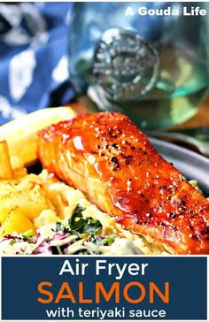 air fryer salmon with teriyaki sauce on a bed of vegetables and potatoes