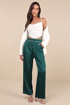 Playful and chic at the same time, the Lulus Sophisticated Step Emerald Satin Wide-Leg High-Rise Pants are essential for elevating your workweek looks! Sleek woven satin shapes these statement-making pants with a high waist, a hidden zip fly, and top clasp closures. White contrast piping accents the waist and wide legs, continuing down the side seams to ankle-length hems. Pleated details, functional front diagonal pockets, and a decorative back welt pocket complete the look. Fit: This garment fi Satin Pants, Chic Office, High Rise Pants, Bottom Clothes, Ankle Length, High Rise, Bottoms Pants, Sleek, Wide Leg