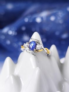 This beautiful ring is a special and unique piece of jewel for you your best friends and a perfect gift for any occasion. It is made entirely of solid sterling silver 925 with 18k Gold plated band. The ring comes also with two small real pearls and a blue star sapphire stone. Feyre's wedding ring is described has "ring of twisted strands of gold and silver, flecked with pearl, and set with a stone of deepest solid blue; sapphire but different. The pale lines of a six-pointed star radiate across the round, opaque surface of the bluestone" Product details: Material: Sterling Silver Colour: Silver, 18k Gold Size: 3US - 4US - 5US - 6US - 7US - 8US - 9US - 10US - 11US - 12US - 13US From A Court of Thorns and Roses by Sarah J. Maas, ©2015. Created with permission of Writers House LLC acting as a Feyre Wedding, Star Sapphire Stone, Feyre Rhysand, Sapphire Wedding Ring, Roses Book, Feyre And Rhysand, Sapphire Wedding Rings, Blue Star Sapphire, Court Of Thorns And Roses